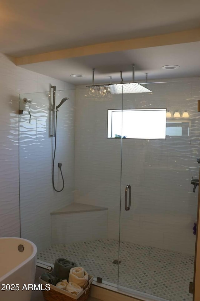 bathroom featuring independent shower and bath