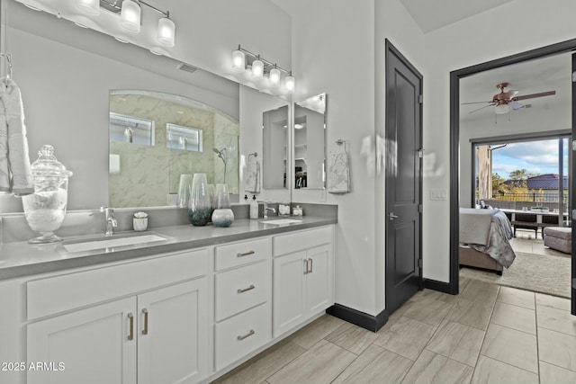 full bath featuring double vanity, a walk in shower, visible vents, and a sink