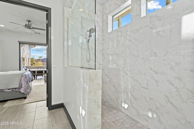 ensuite bathroom featuring connected bathroom, a walk in shower, baseboards, and ceiling fan