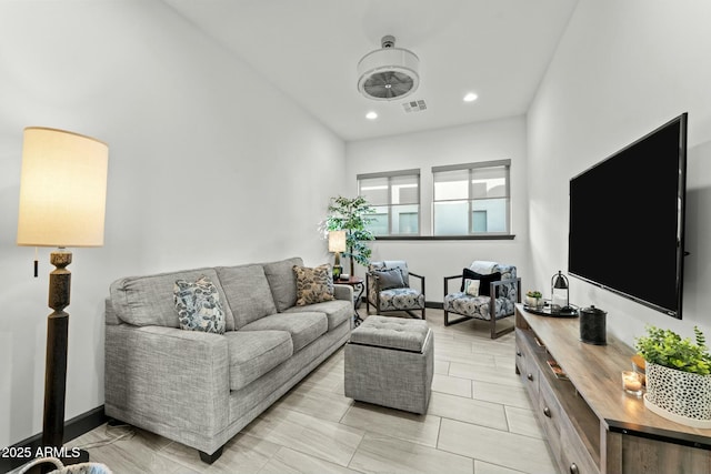 living room with recessed lighting, visible vents, and baseboards