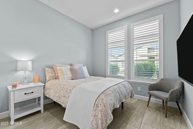 bedroom with wood finish floors, recessed lighting, and baseboards