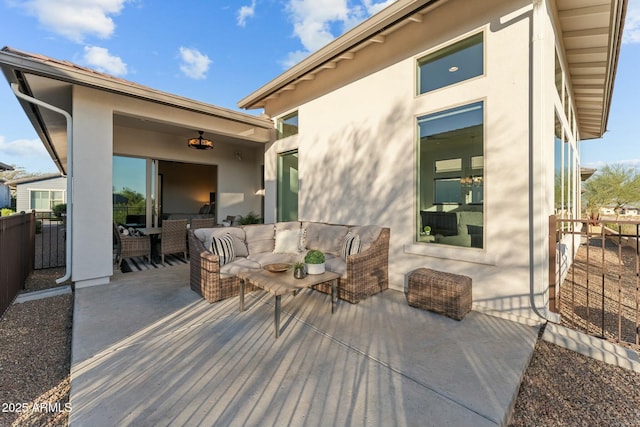 view of patio with an outdoor living space and fence