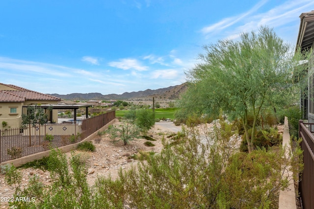 view of yard with fence and a mountain view