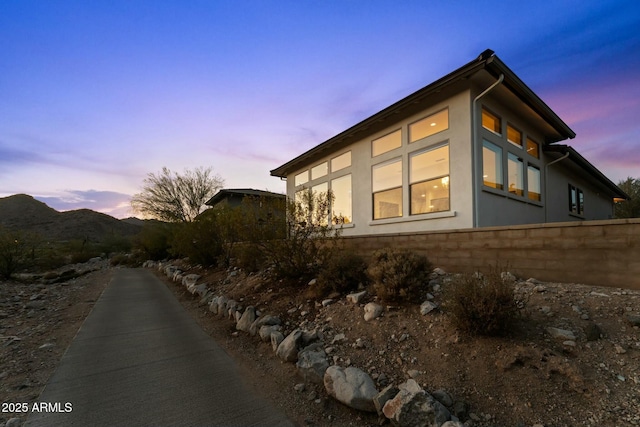 property exterior at dusk with stucco siding