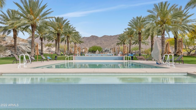 community pool featuring a patio area and a mountain view