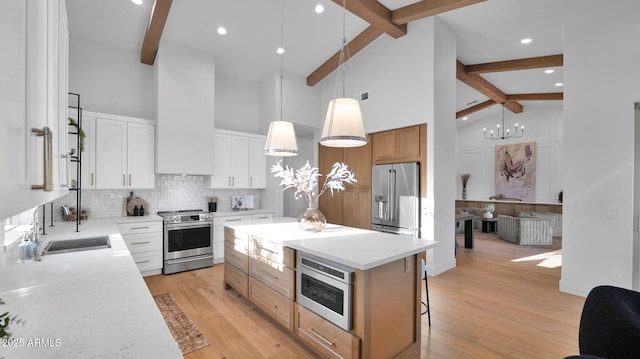 5103 E Juniper Ave, Scottsdale, AZ 85254 - kitchen featuring stainless steel appliances, high vaulted ceiling, beamed ceiling, backsplash, and a kitchen island
