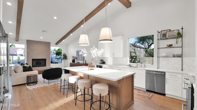 5103 E Juniper Ave, Scottsdale, AZ 85254 - kitchen with appliances with stainless steel finishes, beamed ceiling, tasteful backsplash, a breakfast bar area, and open floor plan
