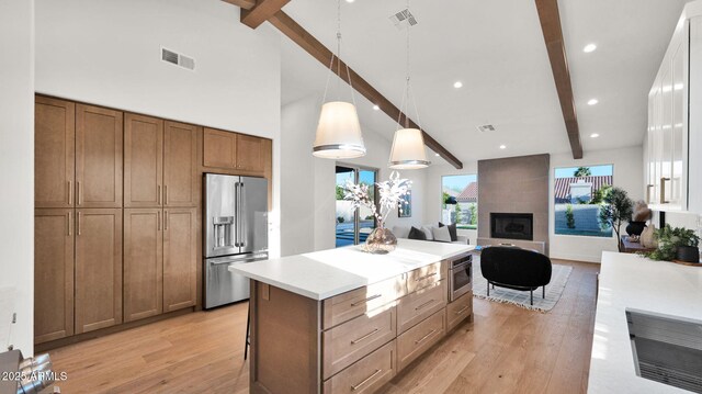 5103 E Juniper Ave, Scottsdale, AZ 85254 - kitchen with stainless steel appliances, beam ceiling, light wood-type flooring, a kitchen island, and light countertops