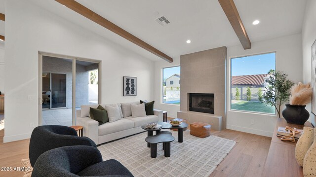 5103 E Juniper Ave, Scottsdale, AZ 85254 - living room featuring light wood-type flooring, healthy amount of natural light, recessed lighting, baseboards, and a tiled fireplace