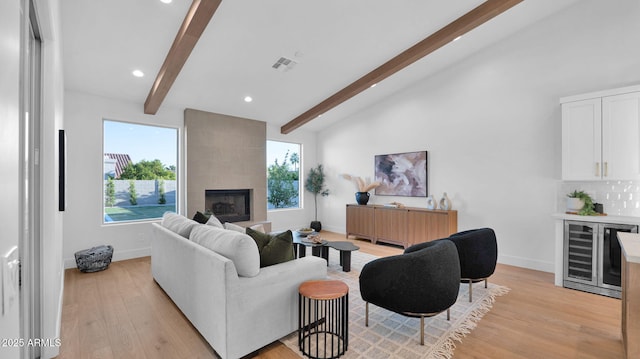 5103 E Juniper Ave, Scottsdale, AZ 85254 - living room with beverage cooler, baseboards, light wood finished floors, a fireplace, and recessed lighting