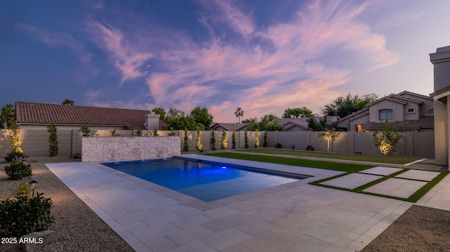 5103 E Juniper Ave, Scottsdale, AZ 85254 - pool at dusk with a patio area and a fenced backyard