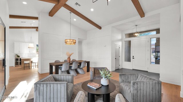 5103 E Juniper Ave, Scottsdale, AZ 85254 - living room featuring high vaulted ceiling, beamed ceiling, a chandelier, wood finished floors, and recessed lighting