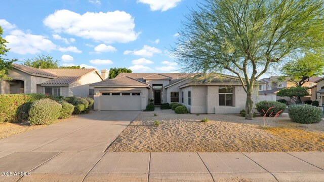 5103 E Juniper Ave, Scottsdale, AZ 85254 - view of front of home with a garage, driveway, stucco siding, a residential view, and a tiled roof