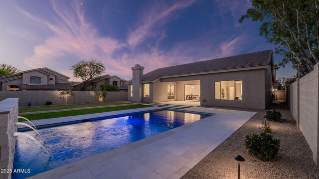 5103 E Juniper Ave, Scottsdale, AZ 85254 - pool at dusk with a patio and a fenced backyard