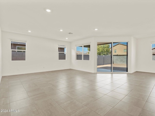 spare room featuring light tile patterned flooring