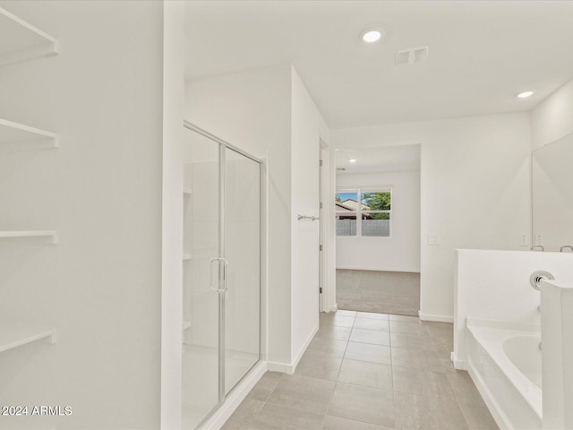 bathroom featuring separate shower and tub and tile patterned flooring