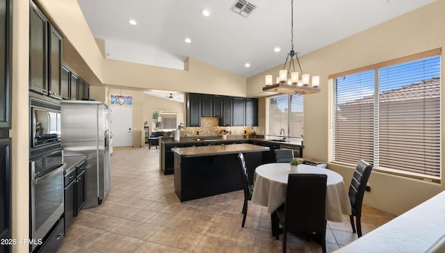 13614 N 12th Way, Phoenix, AZ 85022 - kitchen featuring stainless steel appliances, a center island, visible vents, backsplash, and lofted ceiling