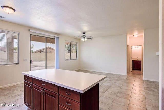 kitchen with a kitchen island and ceiling fan