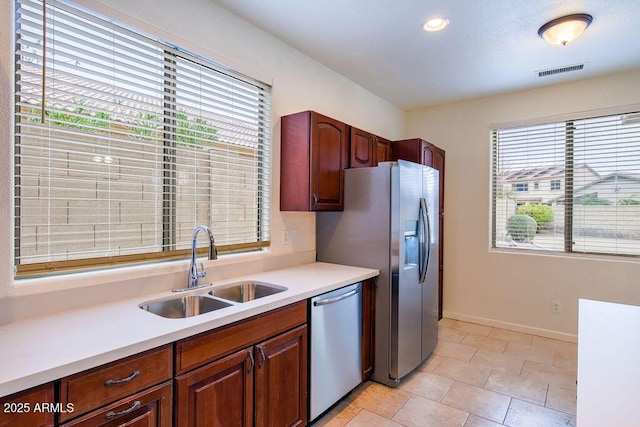 kitchen featuring sink, light tile patterned flooring, and appliances with stainless steel finishes