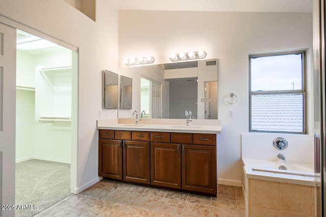 bathroom featuring vanity and a tub