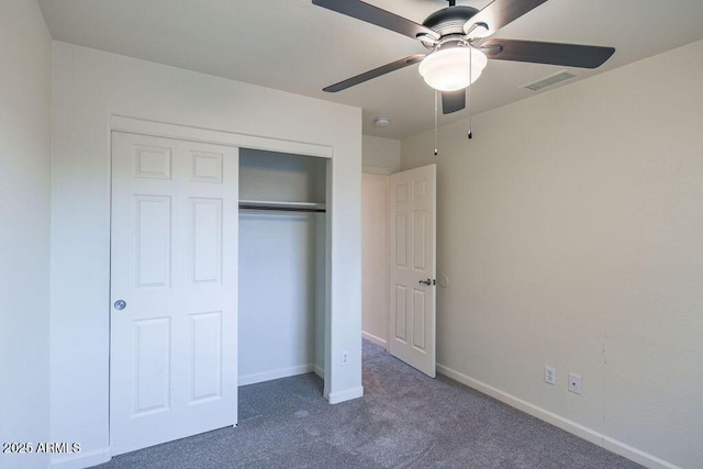 unfurnished bedroom with a closet, ceiling fan, and dark colored carpet