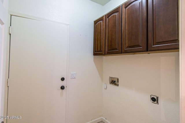 clothes washing area with washer hookup, cabinets, and hookup for an electric dryer