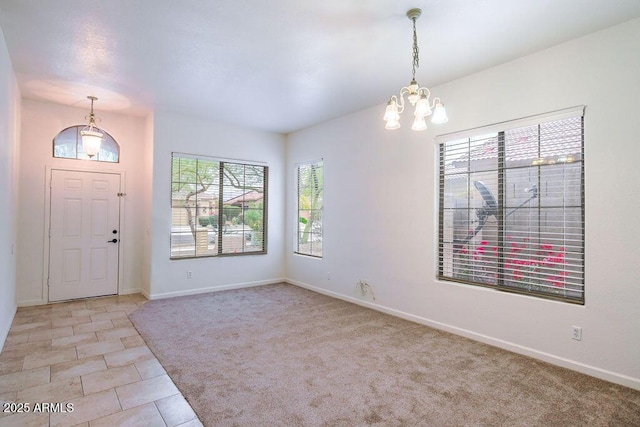 tiled entrance foyer with a chandelier