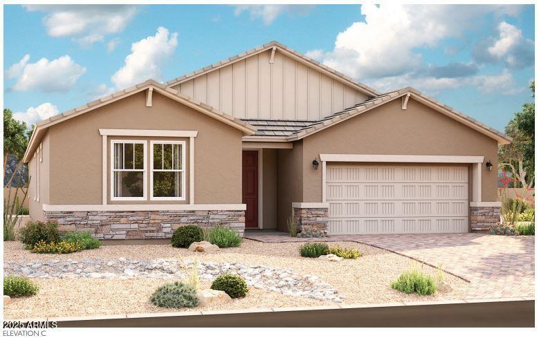 ranch-style home featuring a garage, stone siding, a tiled roof, decorative driveway, and stucco siding