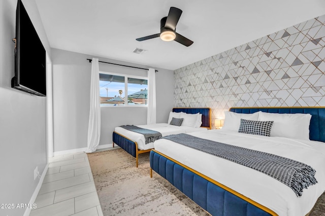 8243 E Montecito Ave, Scottsdale, AZ 85251 - bedroom featuring baseboards, tile patterned floors, a ceiling fan, an accent wall, and visible vents