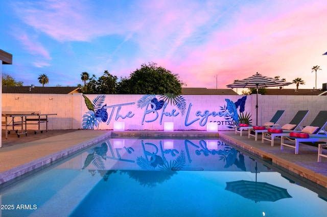8243 E Montecito Ave, Scottsdale, AZ 85251 - pool at dusk featuring a patio area and a fenced backyard