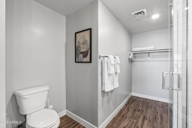 full bathroom featuring baseboards, toilet, and wood finished floors