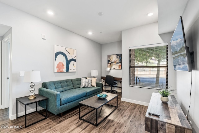 living room featuring wood finished floors, baseboards, and recessed lighting