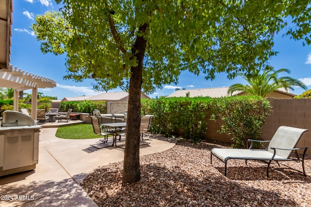 view of patio with a pergola and area for grilling