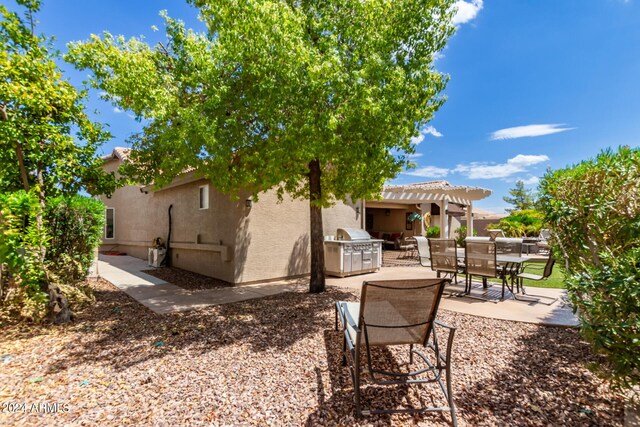 exterior space with a patio area and a pergola