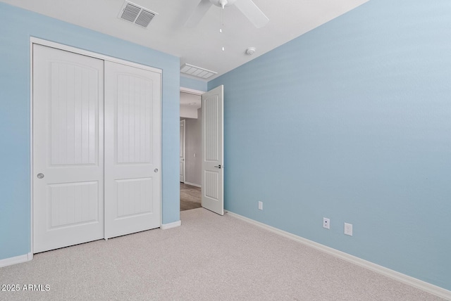 unfurnished bedroom with a closet, visible vents, carpet flooring, and baseboards