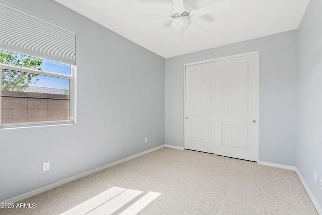 unfurnished bedroom featuring baseboards, a closet, and ceiling fan