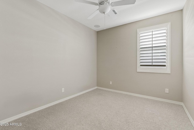 carpeted empty room with baseboards, visible vents, and ceiling fan