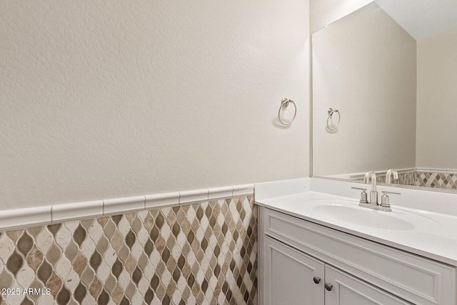 bathroom featuring a wainscoted wall and vanity