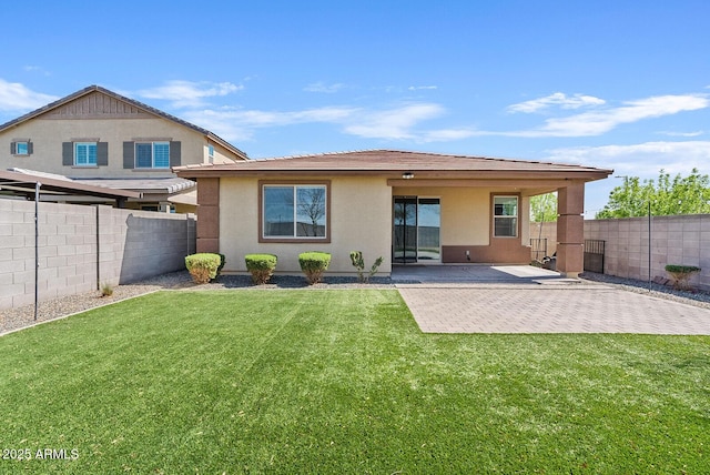 back of house featuring a patio, a lawn, a fenced backyard, and stucco siding