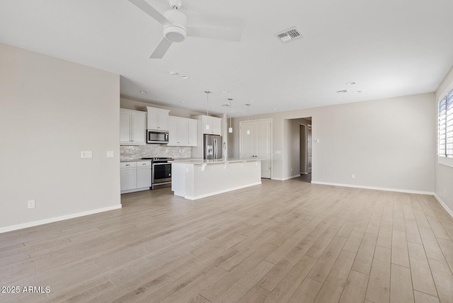 unfurnished living room featuring visible vents, baseboards, recessed lighting, light wood-style flooring, and a ceiling fan