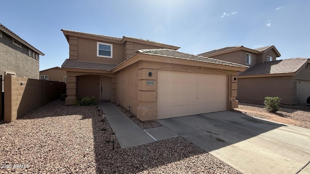 view of front facade with fence, driveway, an attached garage, stucco siding, and a tile roof