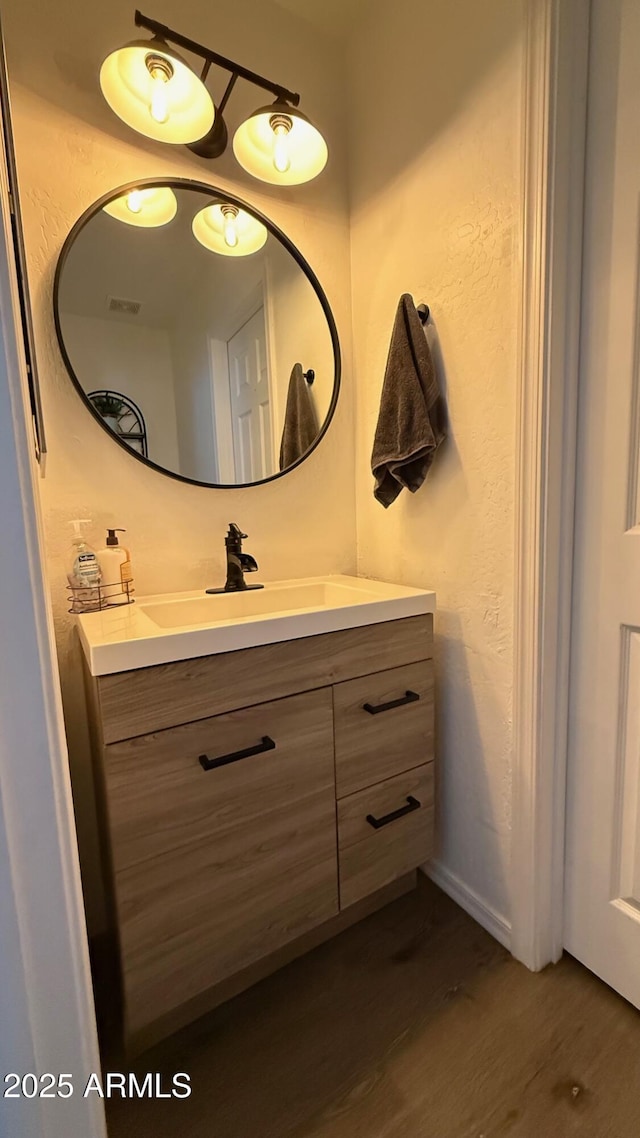 bathroom with vanity, wood finished floors, and visible vents