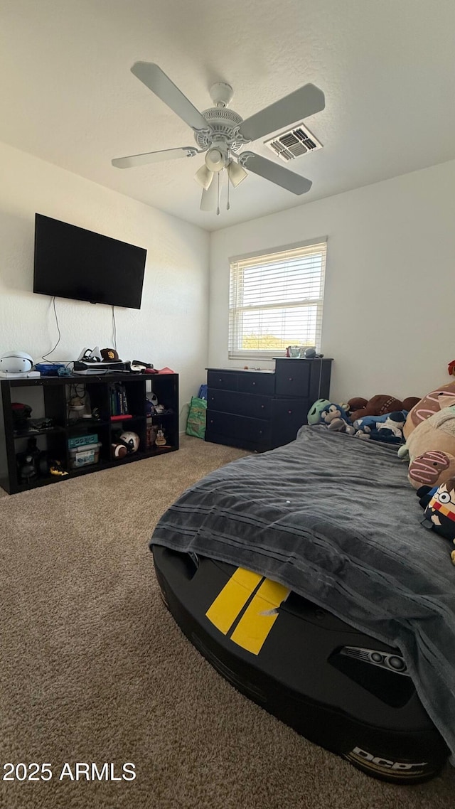 bedroom with visible vents, ceiling fan, and carpet flooring