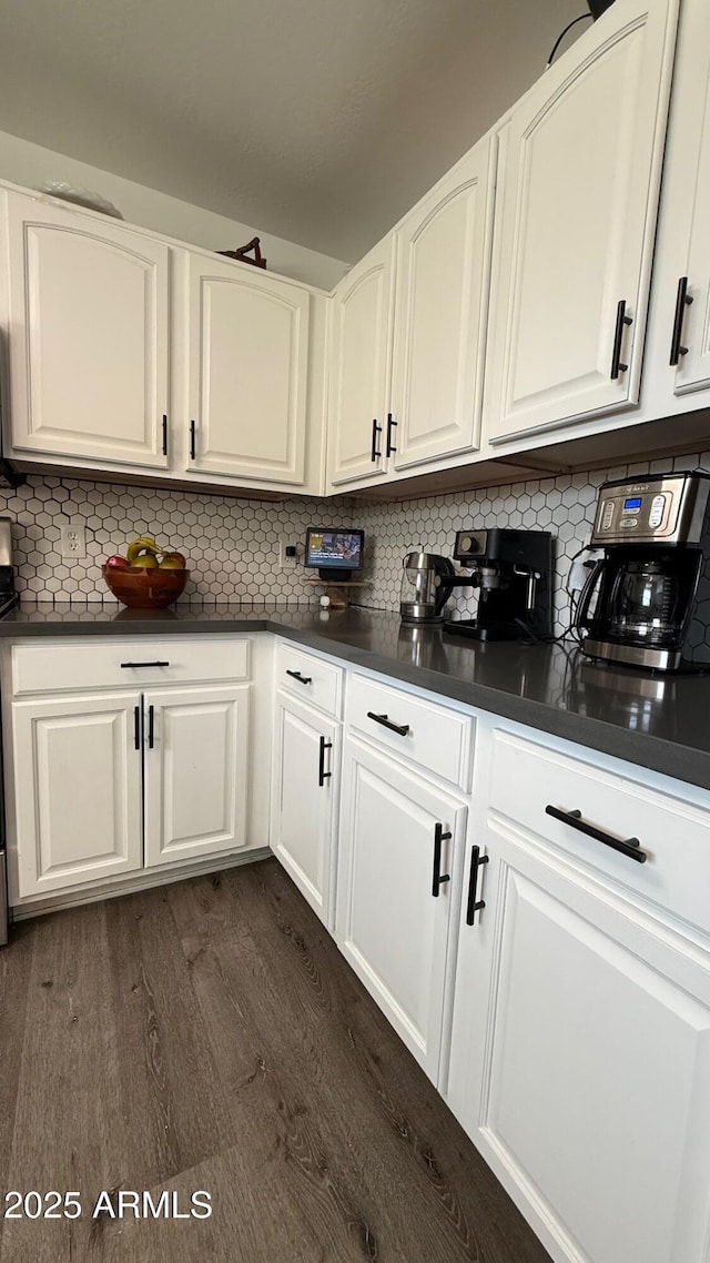 kitchen featuring dark countertops and white cabinetry