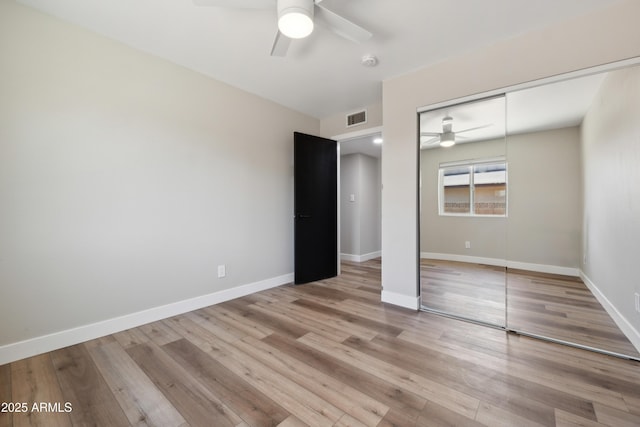 unfurnished bedroom with ceiling fan, a closet, and light hardwood / wood-style floors