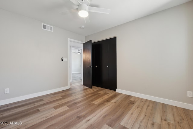 unfurnished bedroom with ceiling fan and light wood-type flooring