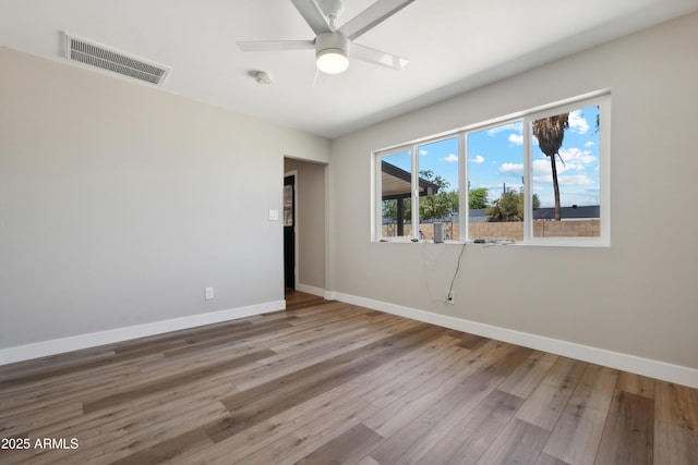 spare room featuring hardwood / wood-style floors and ceiling fan