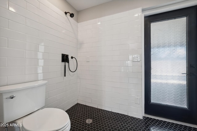 bathroom featuring toilet and tiled shower