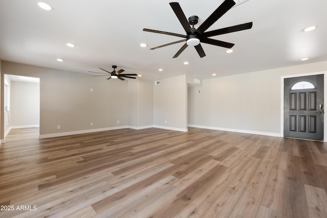 unfurnished living room with light hardwood / wood-style floors and ceiling fan