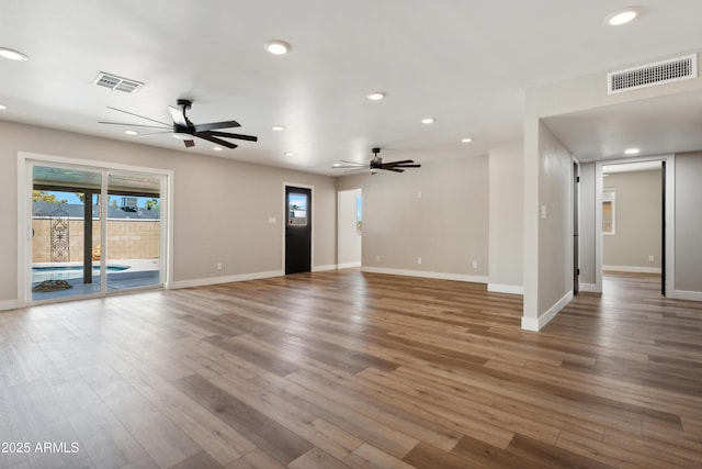 unfurnished living room featuring hardwood / wood-style floors and ceiling fan